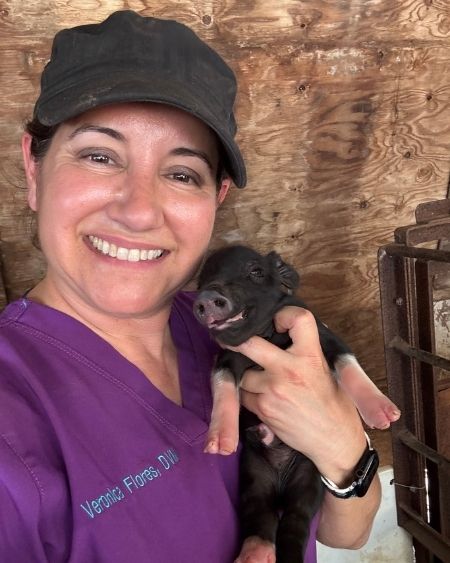 Texas West Animal Health Staff holding a piglet