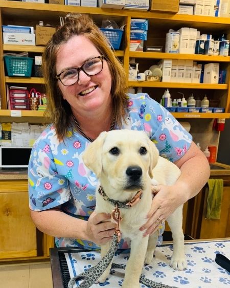 Texas West Animal Health Staff holding a puppy on the exam table