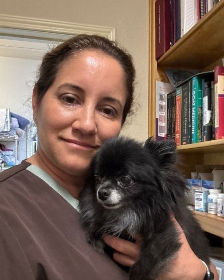 Texas West Animal Health Staff holding a small fluffy dog