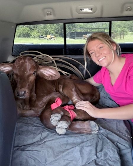 Texas West Animal Health Staff posing with a calf