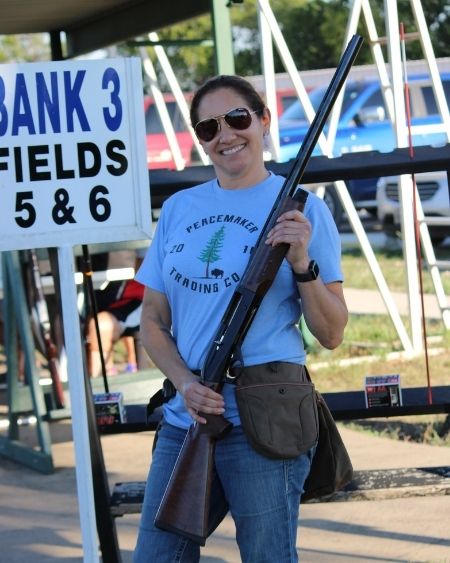 Texas West Animal Health Staff posing with a gun
