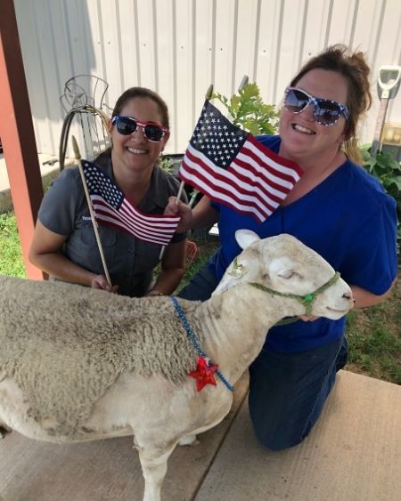 Texas West Animal Health Staff posing with a sheep