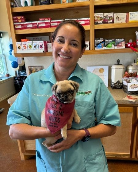 Texas West Animal Health Staff posing with a small pug