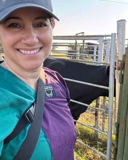 Texas West Animal Health Staff smiling in front of a cattle pen